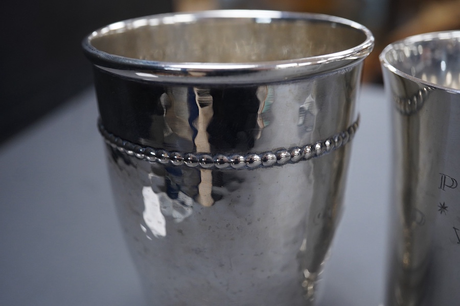 An Elizabeth II silver beaker, with engraved initials, makers TW over BD, London, 1992, 87mm, together with a 1920's hammered Danish white metal beaker and a 19th century French 950 standard white meal beaker, 9.8oz.